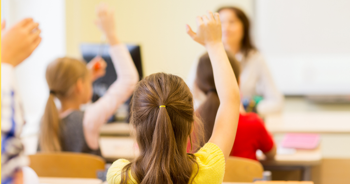 StudentGamification-Blog Students raising their hands in a classroom
